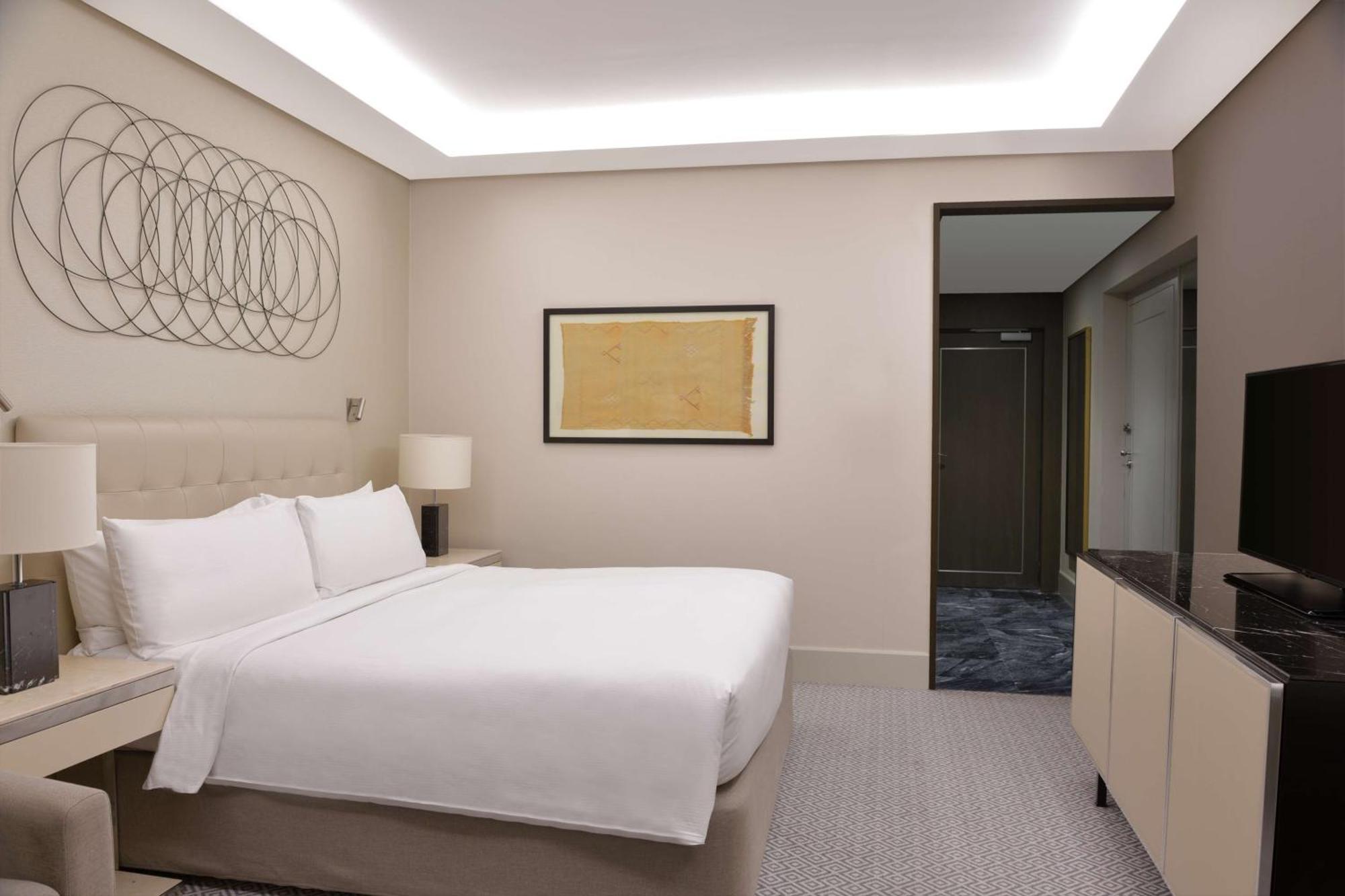 Hilton Tanger City Center Bagian luar foto A bedroom at the hotel